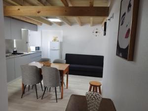 a kitchen and dining room with a table and chairs at Casa Baptista II in Marinha Grande