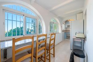 a kitchen with a table and chairs in a room at Luxury Villa Pomelo, Doña Pilar, Mijas in Mijas