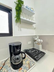 a blender sitting on top of a kitchen counter at Staycation Calaca in Calaca