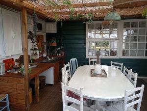 a kitchen with a white table and chairs in a room at chez Margot in Le Tampon +77 photos