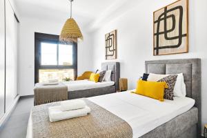 a bedroom with two beds with yellow pillows at Casa Naranja in Pilar de la Horadada +39 photos