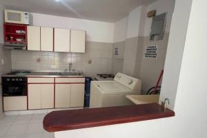 a small kitchen with a sink and a stove at Apartamento tranquilo rodadero in Rodadero
