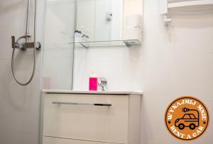 a bathroom with a shower and a sign on the wall at ADLER Room Suite in Łódź +21 photos