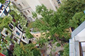an overhead view of a building with a tree at Kunsthaus Apartments in Vienna
