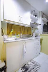 a kitchen with a sink and a counter top at Cityscape Grand in Cebu City