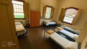 Postel nebo postele na pokoji v ubytování Brumas Ouro Preto Hostel e Pousada