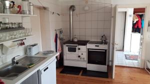 a kitchen with a sink and a stove at Ferienhaus Mesnerhaus Steuerberg in Feldkirchen in Kärnten