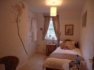 a small bedroom with a bed and a window at Tweed View B&B in Peebles