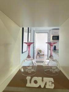 two empty wine glasses sitting on top of a table at Apartamento Victoria Deluxe in Fuente Obejuna +41 photos