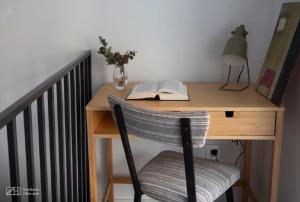 a wooden desk with a chair and a book at Apartments Central Madrid - q2home in Madrid