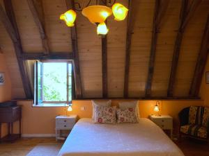 a bedroom with a bed with two lamps and a window at Le Chateau de Busqueilles La Suite in Autoire