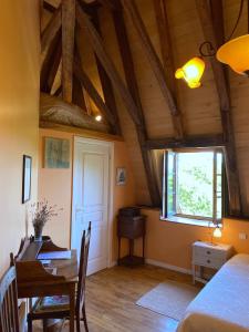 a room with a bed and a table and a dining room at Le Chateau de Busqueilles La Suite in Autoire