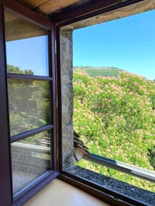 a window with a view of a field of flowers at Le Chateau de Busqueilles La Suite in Autoire