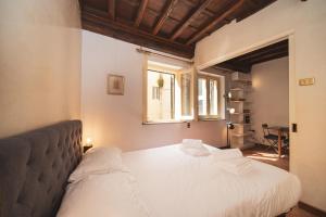 a bedroom with a large bed and a window at Trevi Fountain by BuddyRent in Rome
