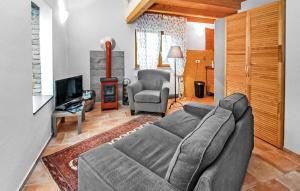 a living room with a gray couch and a television at Ferienwohnung Mirow in Mirow