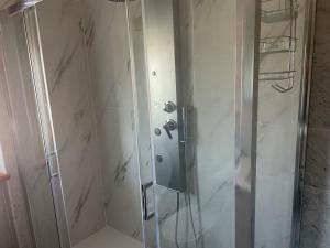 a shower with a glass door in a bathroom at Casa Laura in Rivolta dʼAdda +16 photos
