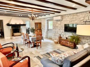 a living room with a stone wall at House Kisic in Višnjan