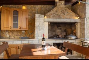 a bottle of wine on a wooden table in a kitchen at Regina 1 in Banjole