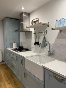 a kitchen with a sink and a stove at Rialto luxury apartments Bath ! in Bath