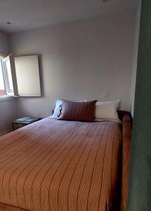 a bedroom with a large bed in a room at Retiro Studio 34 in Guimarães