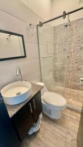 a bathroom with a sink and a toilet and a shower at Hermosa Cabaña Frente Al Mar in San Bernardo del Viento