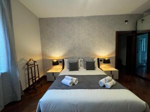 a bedroom with a large bed with two pillows at Villa La Quiete Inn -Private Pool - Parking - Wifi in Castenedolo