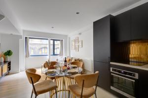 a kitchen and dining room with a table and chairs at Bluestay 123 - Superb apartment in Paris in Paris