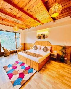 a bedroom with a large bed and a wooden ceiling at ORZU Boutique Stays Manali in Manāli +62 photos