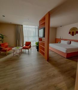 a hotel room with a bed and a couch at Tequendama Hotel Medellín - Estadio in Medellín