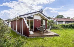 a small house with a deck in a yard at Freibeuterweg 21 - Dorf 5 in Travemünde