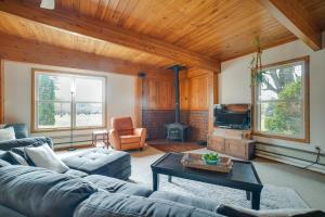 a living room with a couch and a tv at Grand Rural Wisconsin Retreat Full Indoor Gym in Mount Calvary