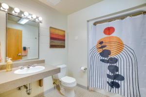 a bathroom with a shower curtain with a toilet and a sink at Grand Rural Wisconsin Retreat Full Indoor Gym in Mount Calvary +37 photos