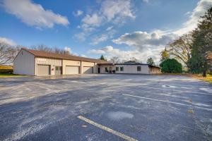 an empty parking lot with a large building at Grand Rural Wisconsin Retreat Full Indoor Gym in Mount Calvary