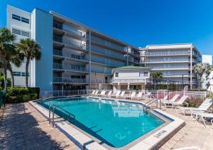 a swimming pool in front of a apartment building at Top floor condo, steps away from JW Marriott and Beach Access!! in Marco Island