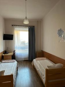 Łóżko lub łóżka w pokoju w obiekcie Hotel Haga