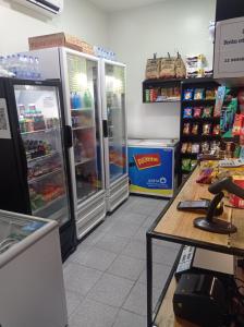 a store with two refrigerators and a phone on a table at flat no centro da Cidade in Campos dos Goytacazes
