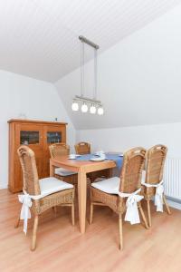 a dining room with a table and chairs at Ferienhaus Boje 13 in Neuharlingersiel +34 photos