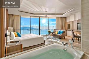 a bedroom with a bed and a bath tub at S79 Residences LYN Panorama Suite in Nha Trang