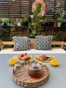 a table with a basket of food on a table at La Casetta, Garden Retreat in Cape Town