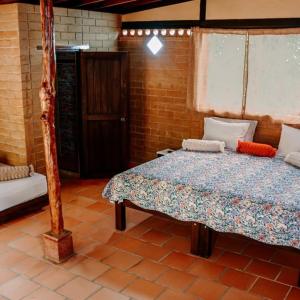 a bedroom with a bed in a room at Villas del bambú in San Gil +68 photos