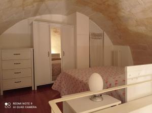 a bedroom with a bed and a dresser in a room at Labanca's l'arco del duomo in Matera