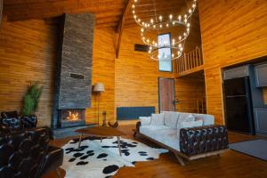 a living room with a couch and a fireplace at Mağmat Resort & Bungalows in Trabzon