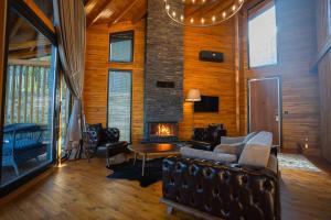 a living room with a couch and a fireplace at Mağmat Resort & Bungalows in Trabzon