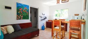 a living room with a couch and a kitchen with a table at Kite House Cabarete across Kite Beach in Cabarete