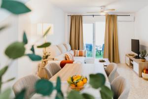 a living room with a table and a couch at Casa Bahía in El Puerto de Santa María