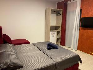 a bedroom with a bed with a blue pillow on it at Star Boutique Villa in Constanţa