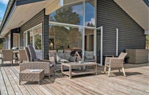 a patio with chairs and a couch and a table at 4 Bedroom Stunning Home In Bording in Bording Stationsby +18 photos