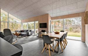 a living room with a table and chairs at 4 Bedroom Stunning Home In Bording in Bording Stationsby