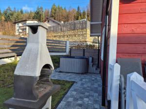 a concrete bird statue next to a building at Domki i Apartamenty Cicha Dolina - jacuzzi, sauna, basen in Szczyrk