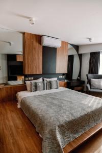 a bedroom with a large bed and a chair at Endless View loft in Mesimvría +37 photos